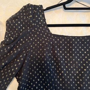 Square neckline fitted blouse with elasticized back.